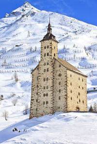 Snow covered buildings against sky