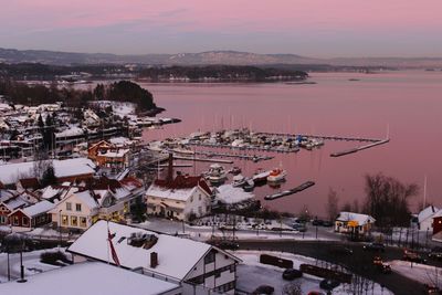 High angle view of cityscape at harbor during winter