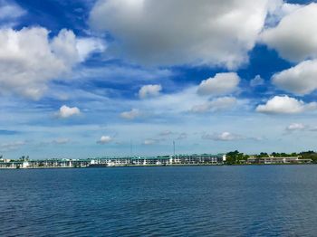 Scenic view of sea by buildings against sky