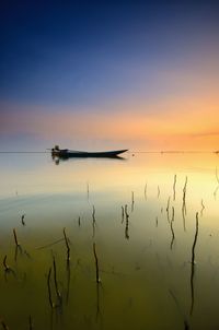 Scenic view of lake against sky during sunset