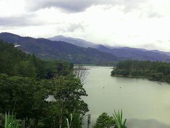 Scenic view of lake and mountains against sky