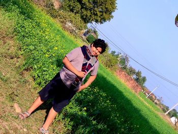 Woman with umbrella on field