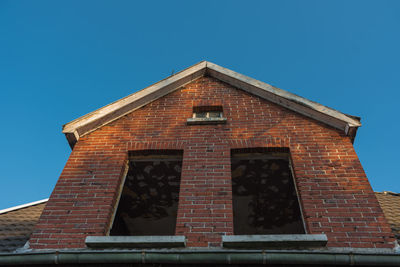 Low angle view of building against clear blue sky