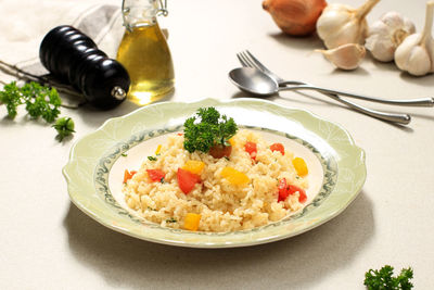 Butter rice nasi goreng or fried rice with red and yellow paprika, menu for breakfast