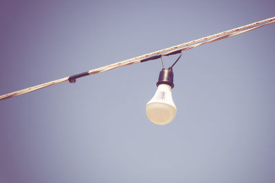 Low angle view of light bulb against clear sky