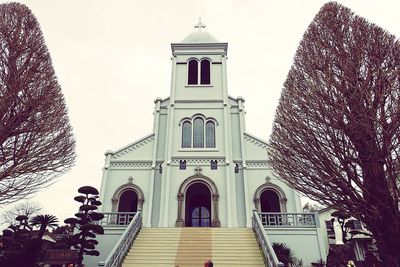 Low angle view of bell tower against sky