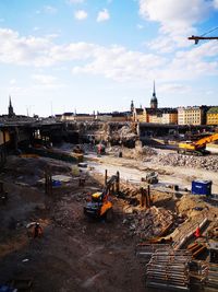 High angle view of construction site by buildings against sky
