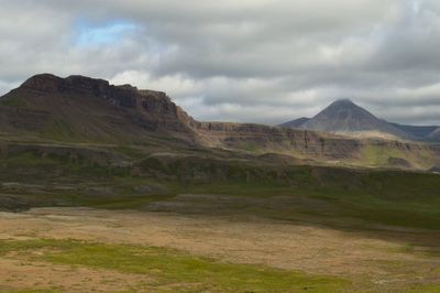 Scenic view of mountains against cloudy sky