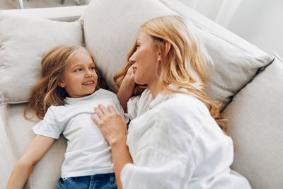 Smiling mother and daughter at home