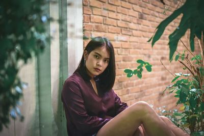 Portrait of young woman sitting outdoors