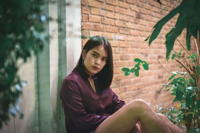 Portrait of young woman sitting outdoors