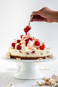 Close-up of hand holding dessert