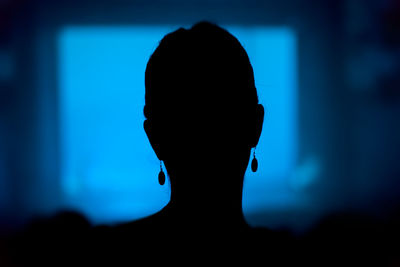 Close-up portrait of silhouette man against black background