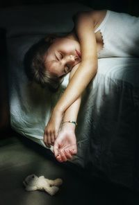Cute girl sleeping on bed at home