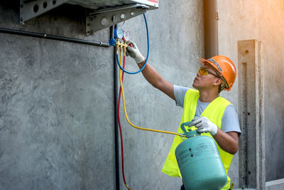 Worker repairing air conditioner