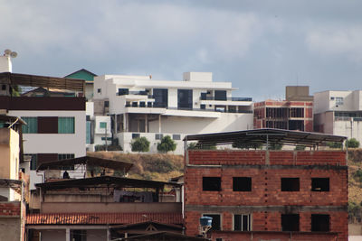 Buildings in city against cloudy sky