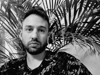 Portrait of young man against plants