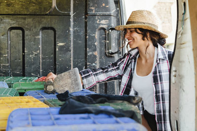 Young woman looking away while sitting in market