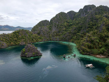Scenic view of river and mountains against sky