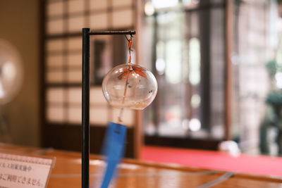 Close-up of light bulb hanging on table