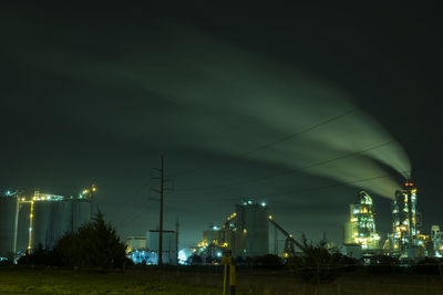 Illuminated trees against sky at night