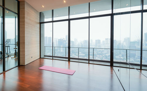 View of empty gym against cityscape