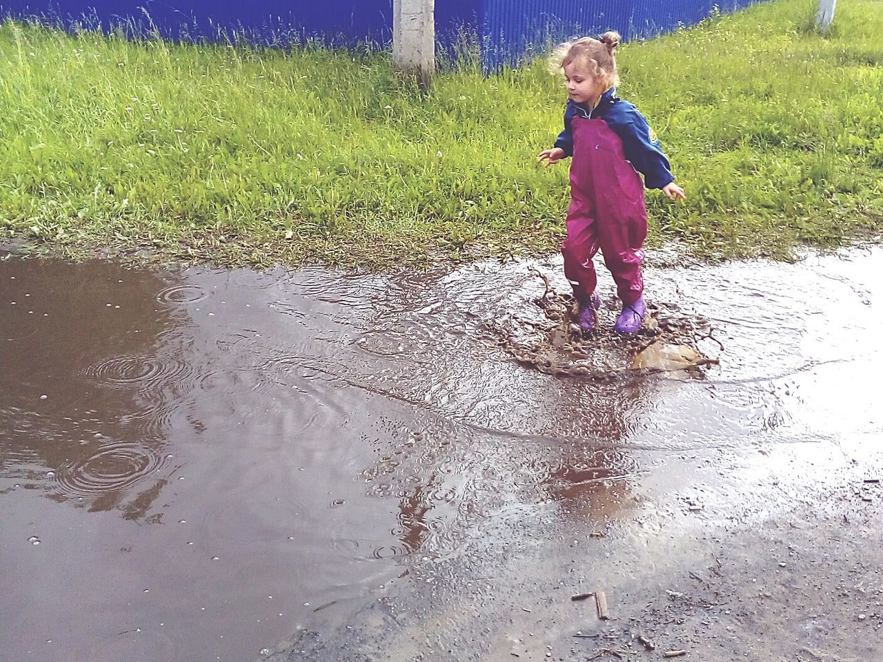 child, childhood, full length, one person, water, females, girls, real people, standing, women, day, land, lifestyles, nature, leisure activity, casual clothing, innocence, rainy season, rain, outdoors