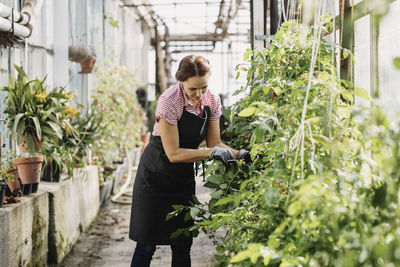 Woman standing in greenhouse