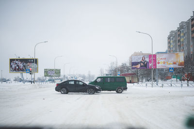 Cars on street in city during winter