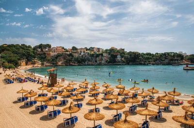 High angle view thatched roof parasols at beach