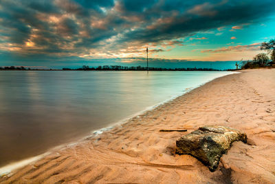 Scenic view of beach against sky during sunset