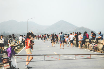 People on road against mountains