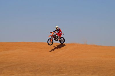 Man riding bicycle on desert