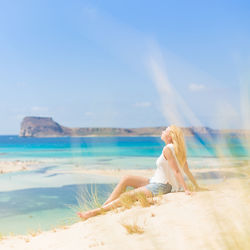 Woman on beach against sky