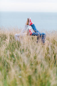 Low section of person amidst plants on field