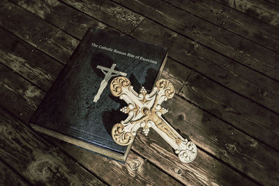 High angle view of cross sculpture on wood outside temple