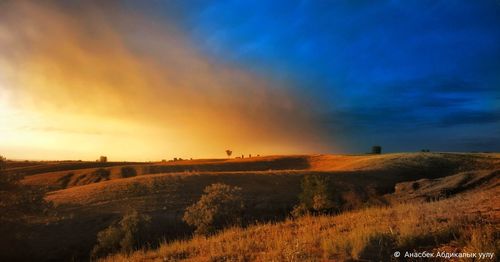 Scenic view of land against sky during sunset