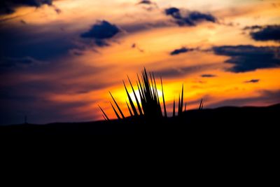 Silhouette of landscape against dramatic sky