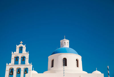 Low angle view of church at santorini against clear sky