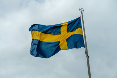Low angle view of swedish flag against sky