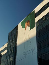 Low angle view of modern building against clear blue sky