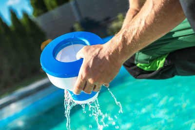 Low section of man washing hands