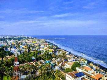 High angle view of townscape by sea against sky