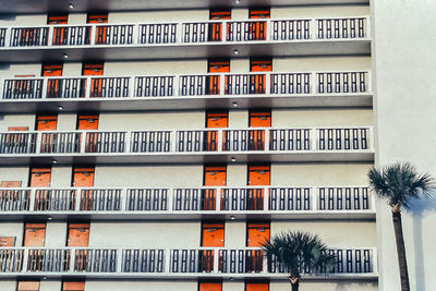 Low angle view of red doors to motel building in the city