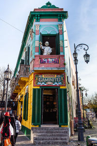 Low angle view of statue against building in city