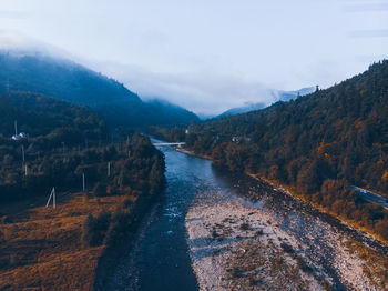 Autumn coming. aerial view of mountains with forest and yellow trees. nature landscape