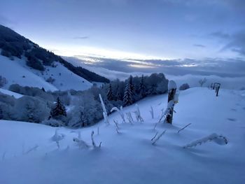 Scenic view of snow covered land against sky