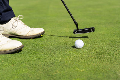 Low section of man playing golf