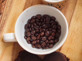 High angle view of coffee beans in bowl on table