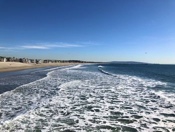 Scenic view of beach against clear blue sky